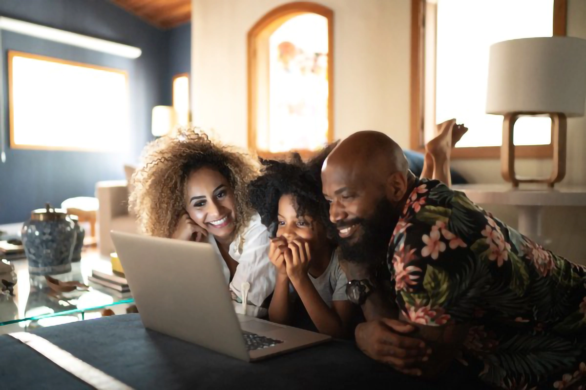 a family using a laptop